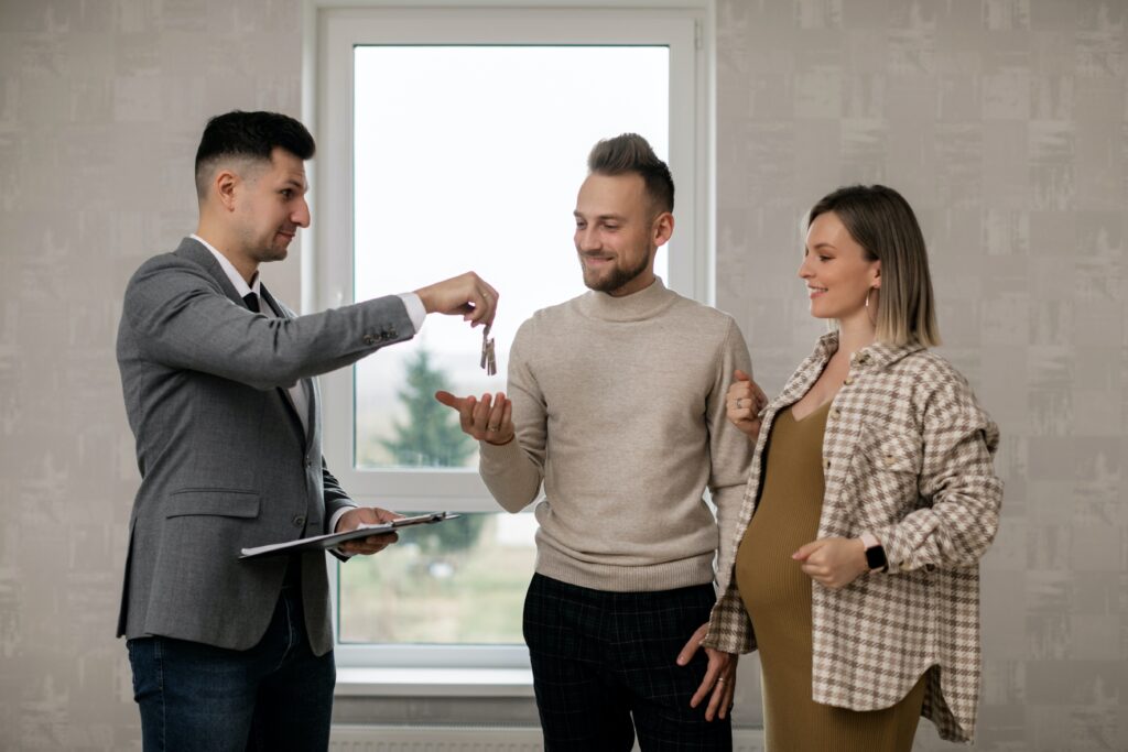 Real Estate Agent Giving Keys to house